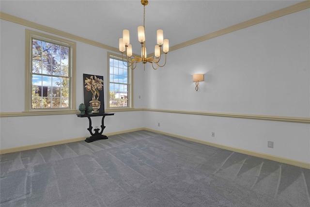 unfurnished room with a chandelier, ornamental molding, carpet flooring, and baseboards