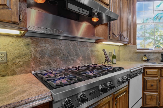 kitchen with white dishwasher, tasteful backsplash, stainless steel gas stovetop, and extractor fan