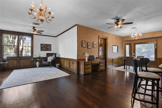 interior space featuring visible vents, a wainscoted wall, dark wood-style flooring, a textured ceiling, and a healthy amount of sunlight