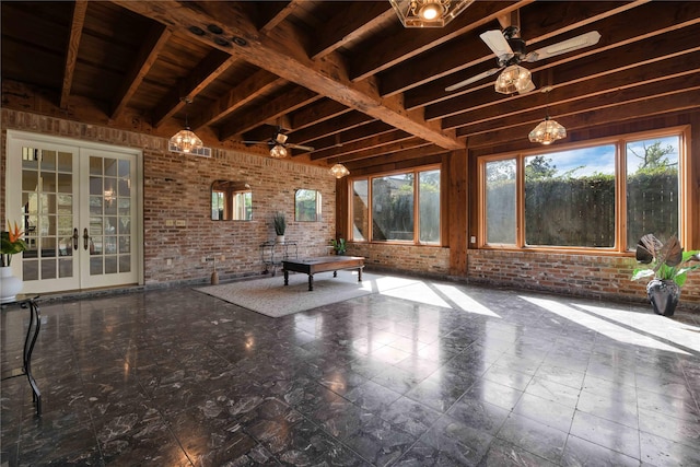 unfurnished sunroom with ceiling fan, beam ceiling, and french doors