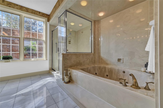 bathroom featuring a whirlpool tub, a stall shower, tile patterned flooring, and baseboards