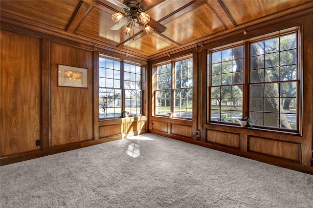 unfurnished sunroom with a ceiling fan, wooden ceiling, coffered ceiling, and beamed ceiling