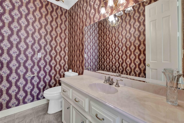 bathroom featuring tile patterned flooring, toilet, vanity, wallpapered walls, and an inviting chandelier