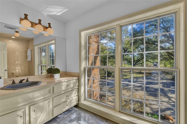 bathroom with marble finish floor, visible vents, and vanity