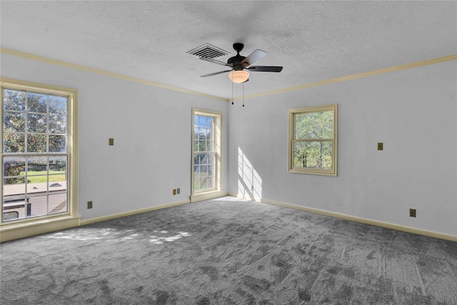 carpeted empty room featuring baseboards, visible vents, a ceiling fan, ornamental molding, and a textured ceiling