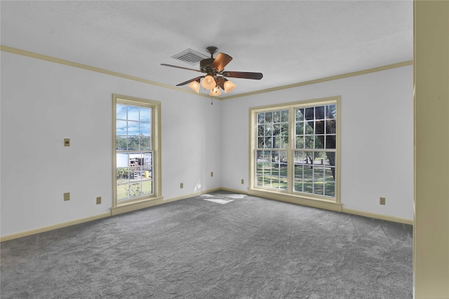 carpeted empty room with ceiling fan, ornamental molding, a textured ceiling, and baseboards