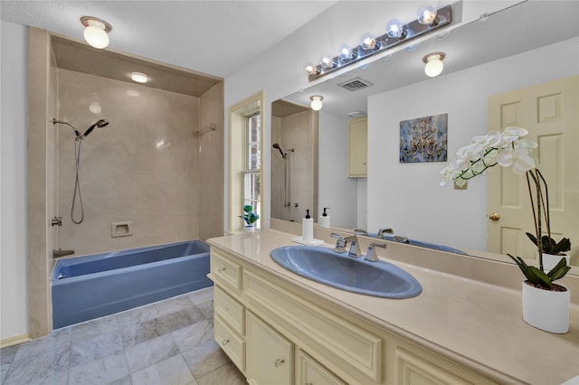 bathroom featuring washtub / shower combination, visible vents, and vanity