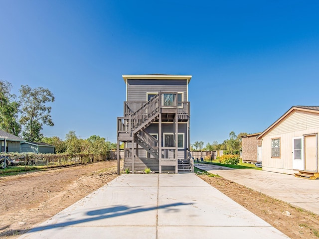 view of front of property featuring stairway and a wooden deck