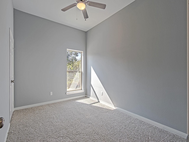 unfurnished room with a ceiling fan, baseboards, and carpet flooring