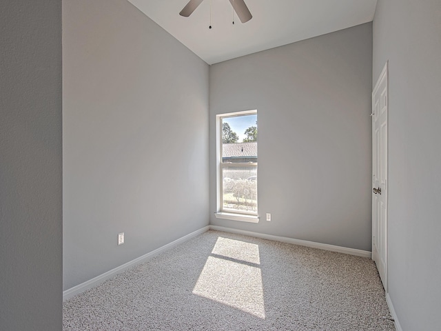 carpeted empty room featuring ceiling fan and baseboards