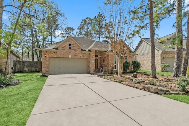 view of front of house featuring brick siding, concrete driveway, fence, a garage, and a front lawn