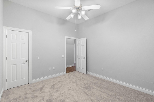 unfurnished bedroom with carpet floors, baseboards, and a ceiling fan