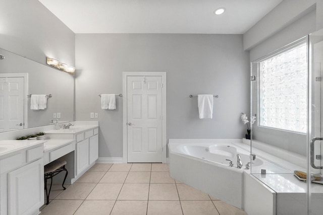 full bathroom featuring a garden tub, a stall shower, vanity, baseboards, and tile patterned floors