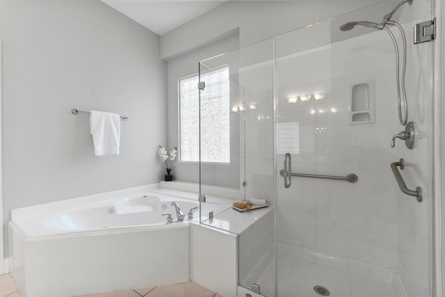 bathroom featuring a stall shower and a garden tub