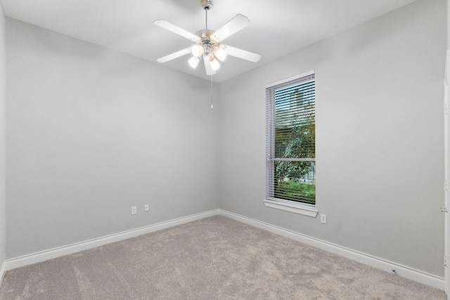 empty room featuring carpet, ceiling fan, and baseboards