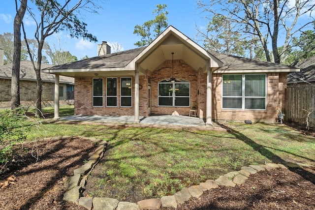 back of house featuring brick siding, a patio, a chimney, ceiling fan, and fence