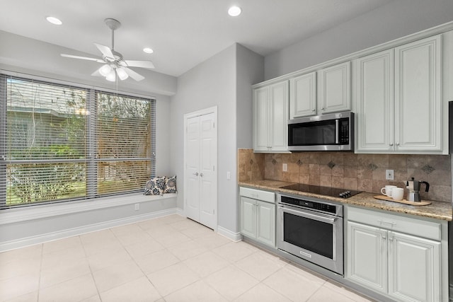 kitchen featuring recessed lighting, decorative backsplash, appliances with stainless steel finishes, ceiling fan, and baseboards