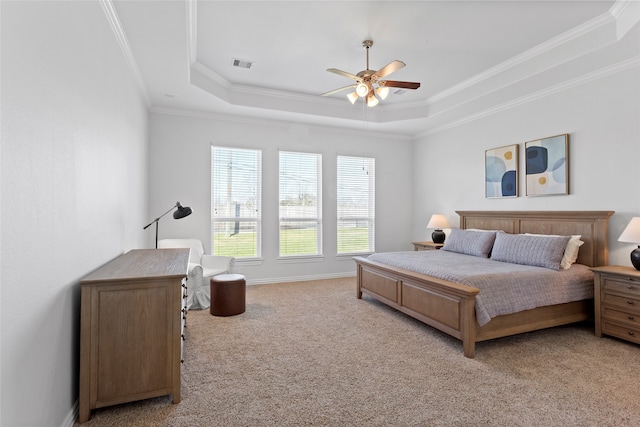 bedroom with a tray ceiling, light colored carpet, visible vents, ornamental molding, and a ceiling fan