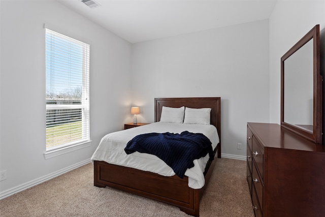 carpeted bedroom with visible vents and baseboards