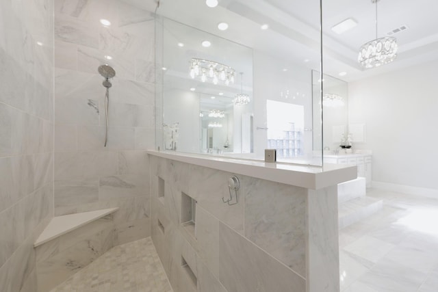 full bathroom featuring a walk in shower, a raised ceiling, visible vents, and baseboards