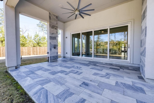 view of patio with ceiling fan and fence