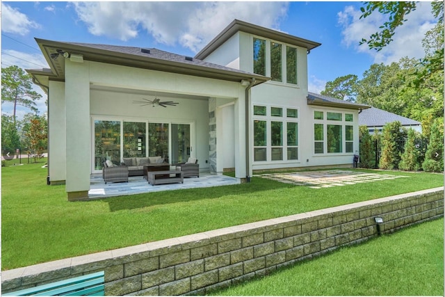 back of house with a lawn, a ceiling fan, a patio, an outdoor living space, and stucco siding