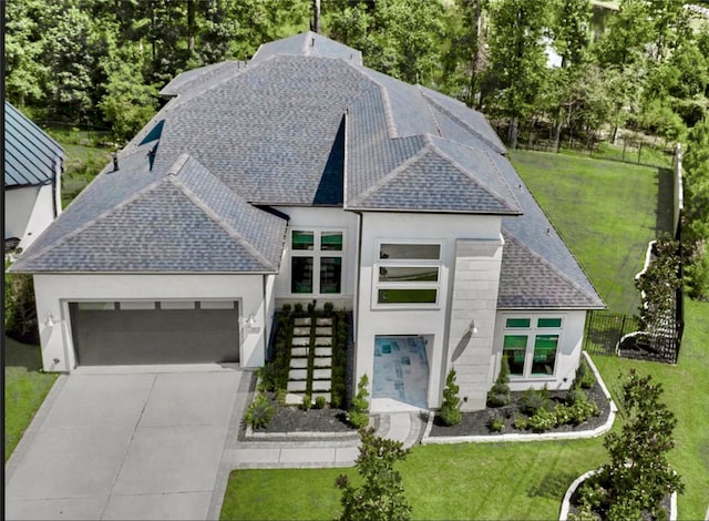 35 Papado Trails Cir, The Woodlands, TX 77375 - view of front of property featuring a shingled roof, a garage, stucco siding, and driveway