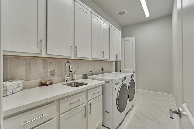 35 Papado Trails Cir, The Woodlands, TX 77375 - washroom with cabinet space, washing machine and dryer, light marble finish flooring, and baseboards