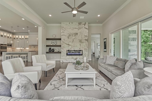 35 Papado Trails Cir, The Woodlands, TX 77375 - living room with ornamental molding, dark wood-type flooring, a ceiling fan, a fireplace, and recessed lighting