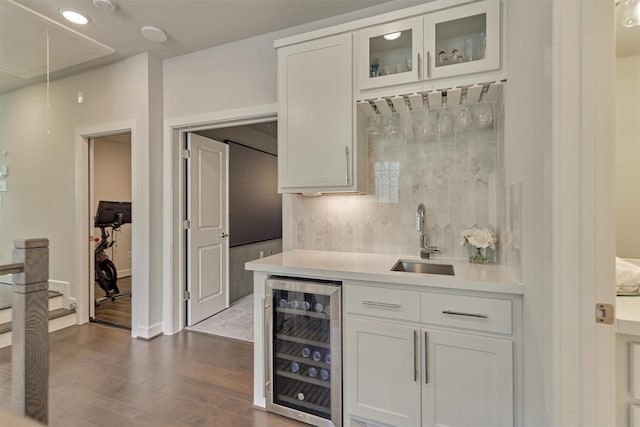 35 Papado Trails Cir, The Woodlands, TX 77375 - indoor wet bar with beverage cooler, dark wood finished floors, backsplash, and baseboards