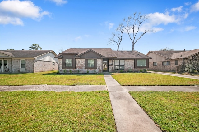 view of front of home featuring a front yard and brick siding