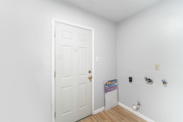 laundry room featuring laundry area, light wood finished floors, baseboards, hookup for a gas dryer, and washer hookup