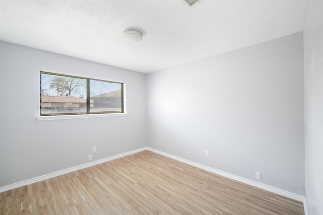 empty room featuring light wood-style flooring and baseboards