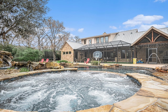 pool featuring a lanai, a jacuzzi, and a patio