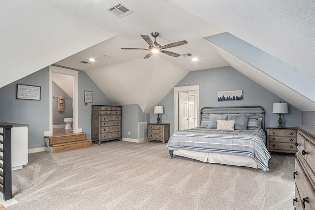 bedroom with vaulted ceiling, carpet floors, visible vents, and baseboards