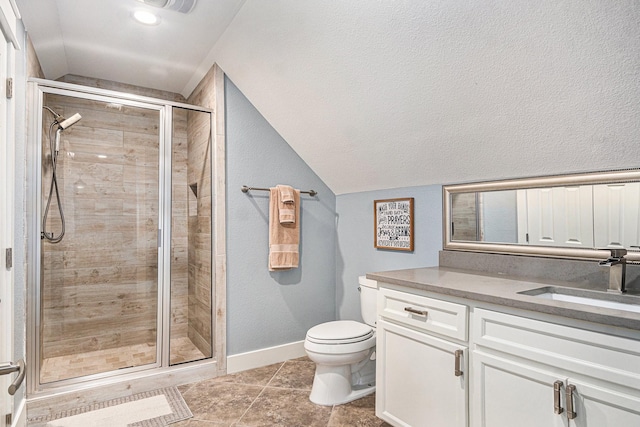 bathroom featuring toilet, a stall shower, vaulted ceiling, vanity, and baseboards