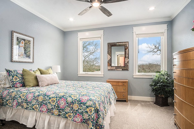 carpeted bedroom featuring crown molding, ceiling fan, and baseboards