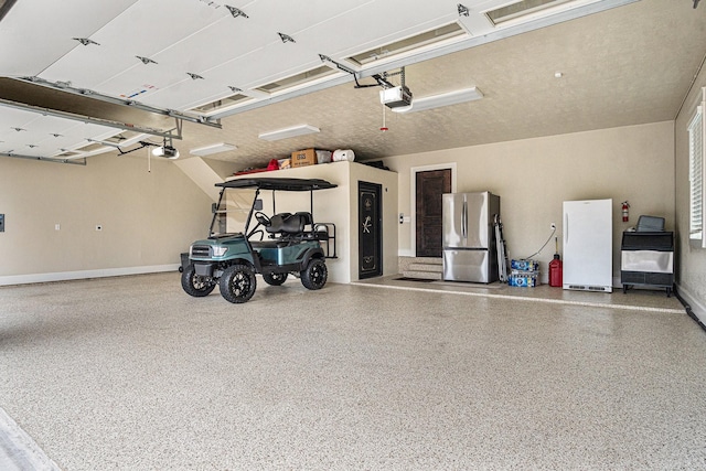 garage with a garage door opener and freestanding refrigerator