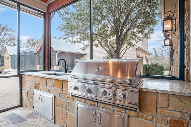 view of patio with area for grilling and a sink