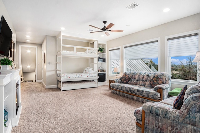 bedroom with baseboards, multiple windows, visible vents, and light colored carpet