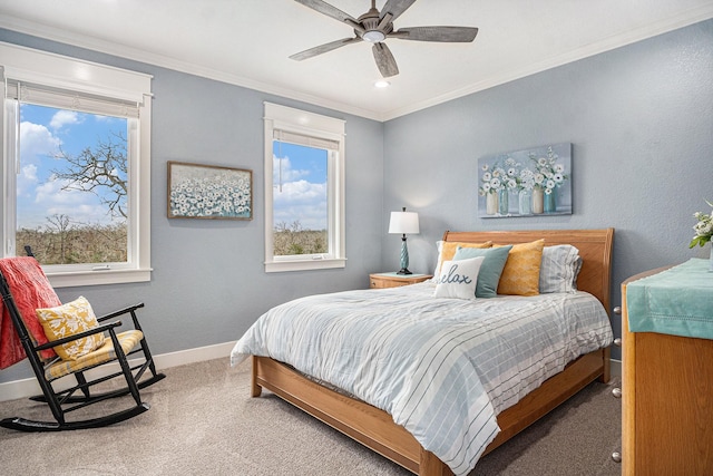 bedroom with carpet floors, ornamental molding, baseboards, and a ceiling fan