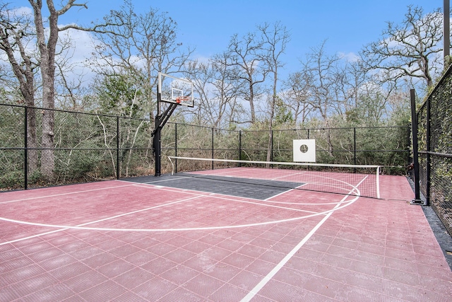 view of basketball court with a tennis court, community basketball court, and fence