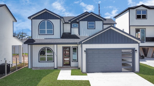 view of front of property featuring driveway, roof with shingles, and an attached garage