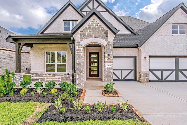 209 Peninsula Point Dr, Montgomery, TX 77356 - view of front of property featuring stone siding, concrete driveway, brick siding, an attached garage, and board and batten siding