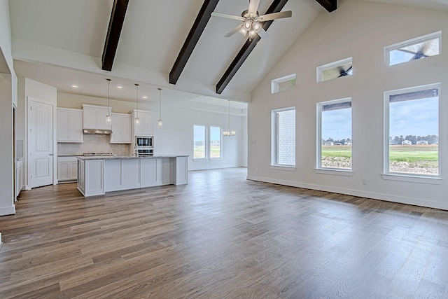 209 Peninsula Point Dr, Montgomery, TX 77356 - unfurnished living room featuring light wood-style flooring, beam ceiling, baseboards, a ceiling fan, and high vaulted ceiling