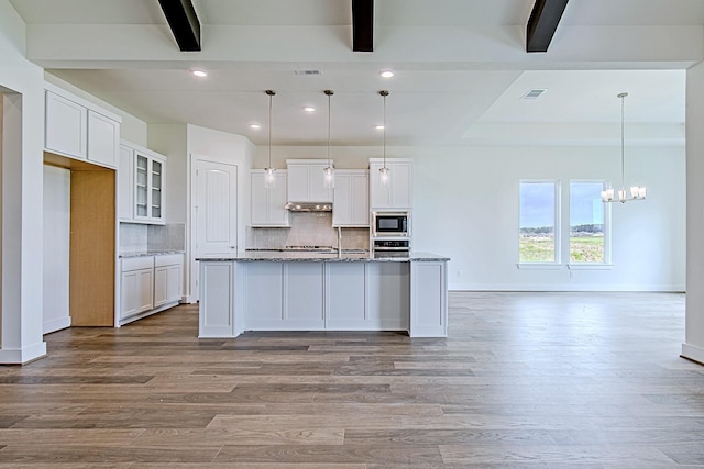 209 Peninsula Point Dr, Montgomery, TX 77356 - kitchen featuring beamed ceiling, baseboards, wood finished floors, and white cabinetry