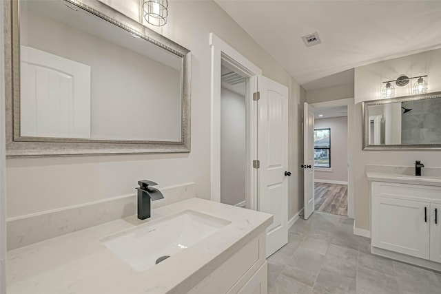 2111 Nina Lee Ln, Houston, TX 77018 - full bath with baseboards, visible vents, a sink, and two vanities