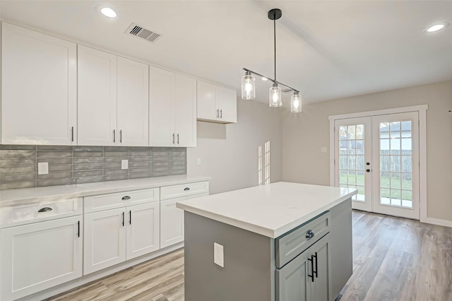 2111 Nina Lee Ln, Houston, TX 77018 - kitchen with gray cabinetry, white cabinets, backsplash, and light countertops