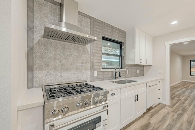 2111 Nina Lee Ln, Houston, TX 77018 - kitchen with stainless steel gas range oven, a sink, wall chimney exhaust hood, and light countertops