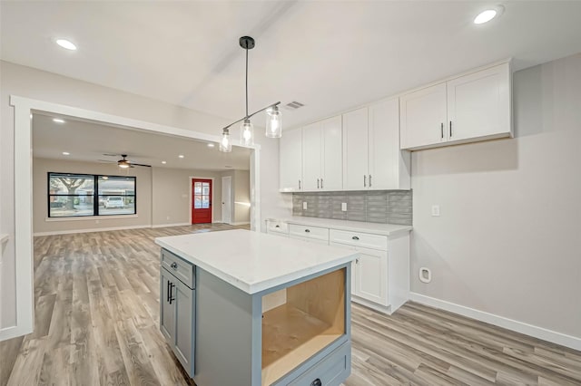 2111 Nina Lee Ln, Houston, TX 77018 - kitchen featuring white cabinetry, tasteful backsplash, visible vents, and light countertops